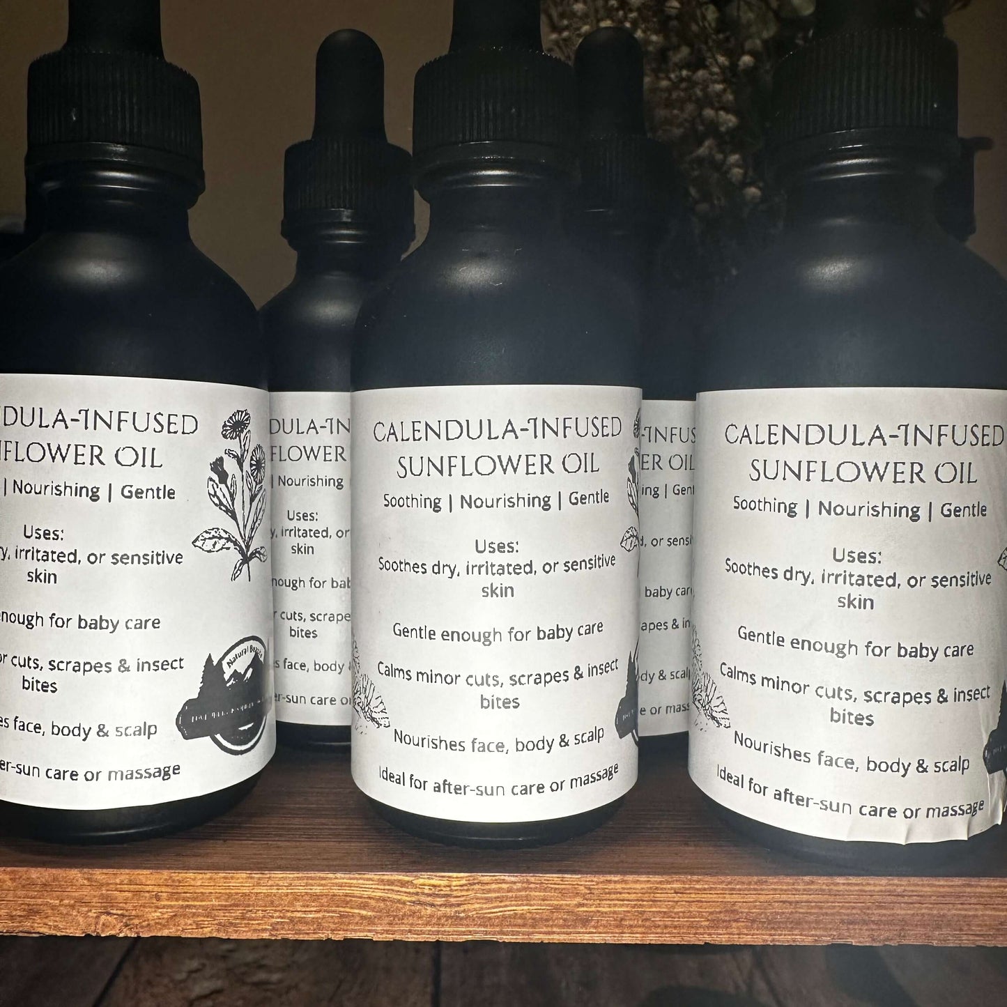 Calendula-infused sunflower oil bottles, soothing for sensitive skin and ideal for after-sun care or massage.