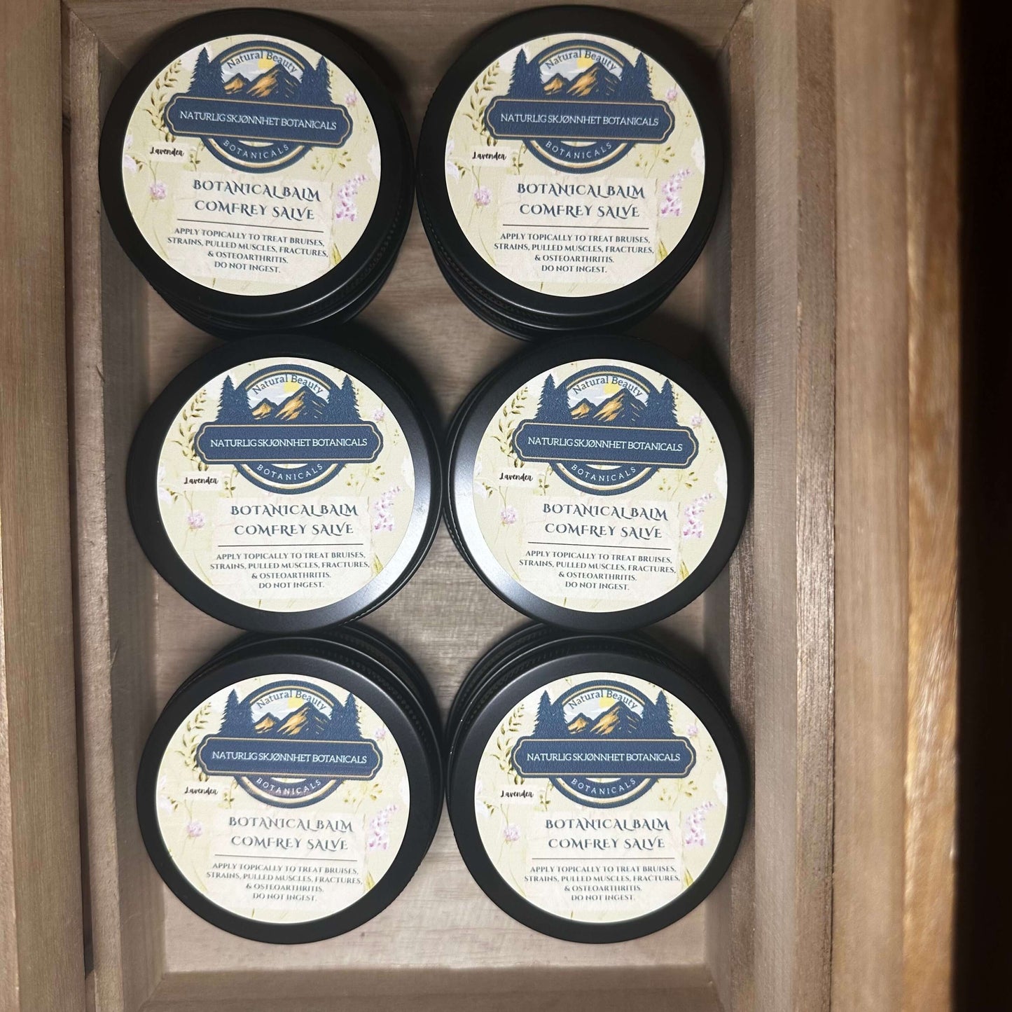 Six jars of Botanical Balm Comfrey Salve, handcrafted salve for soothing skin and joint support.