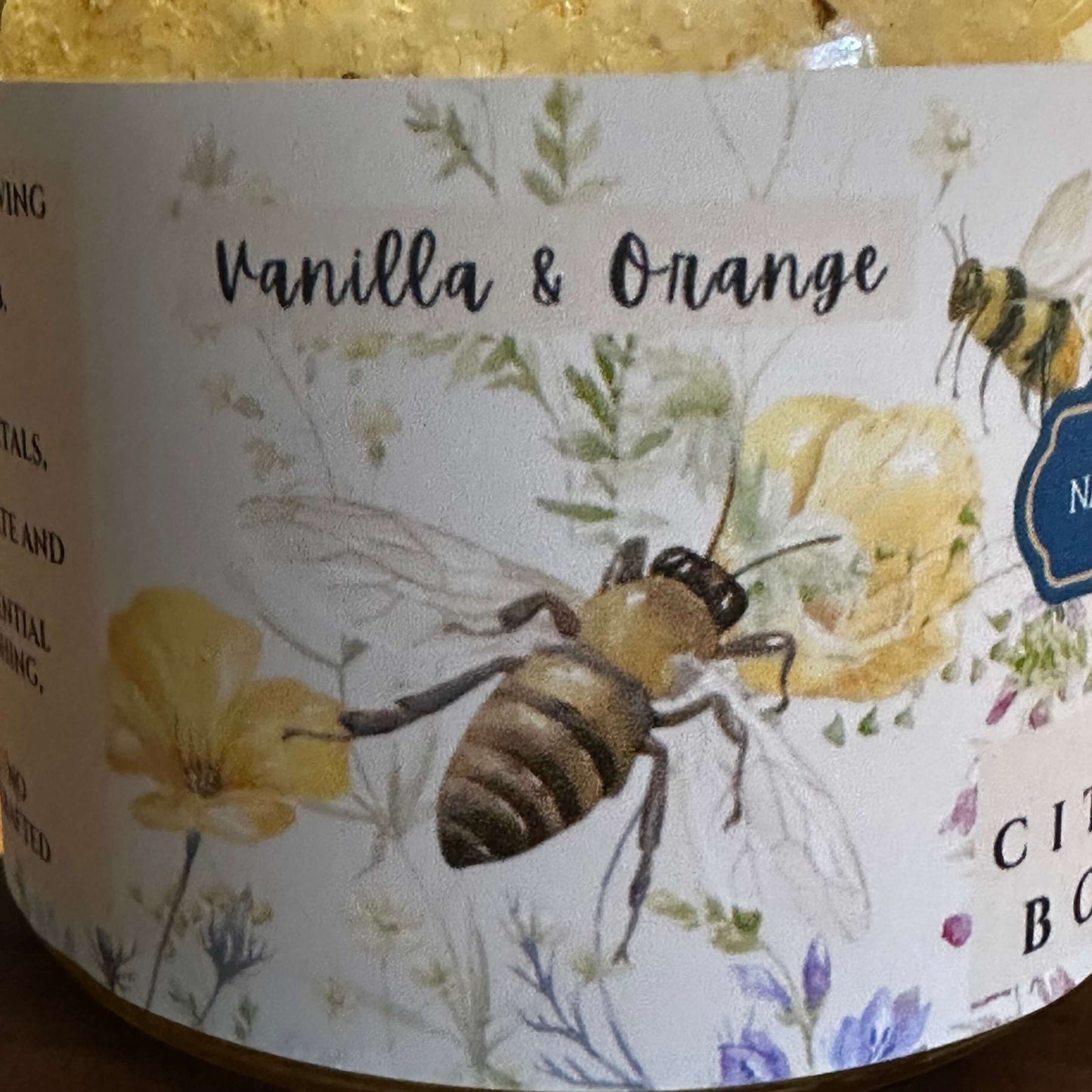 Vanilla and orange body scrub label featuring botanical illustrations and a honeybee design.