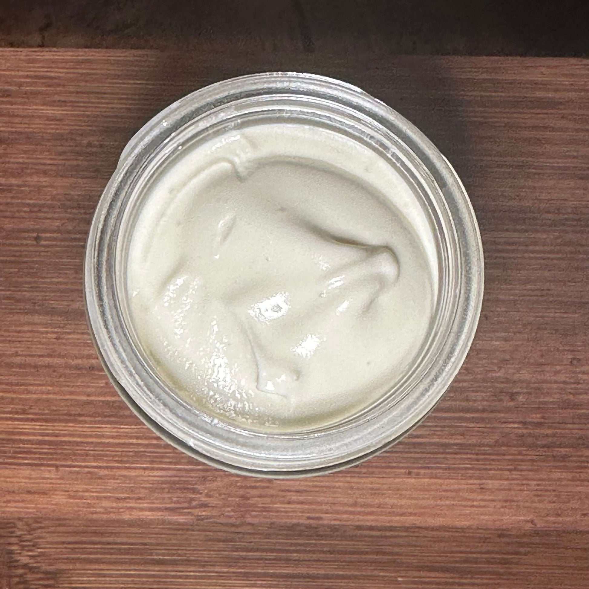 Jar of Summer Shield botanical body butter with creamy texture for sun-exposed skin