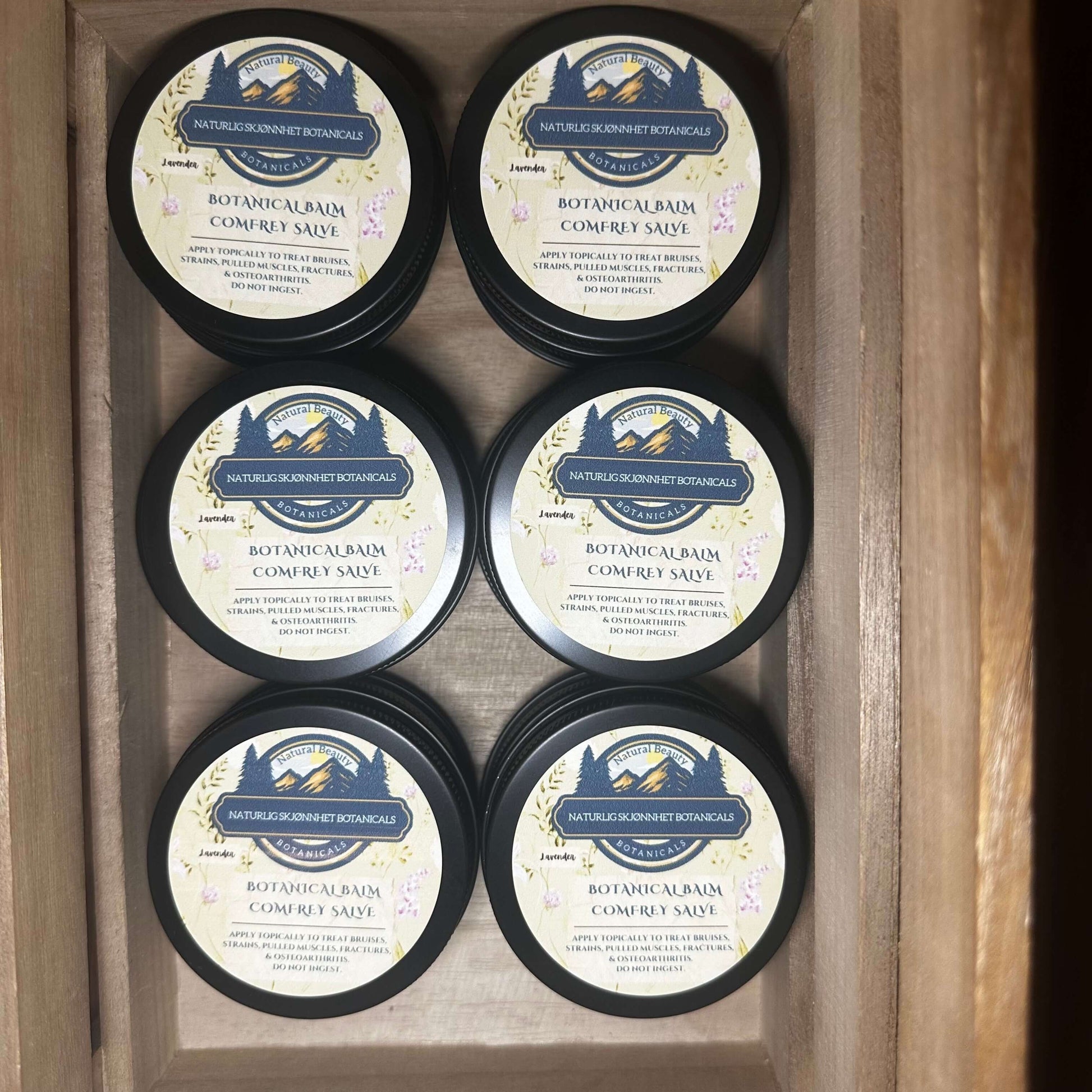 Six jars of Botanical Balm Comfrey Salve, handcrafted salve for soothing skin and joint support.